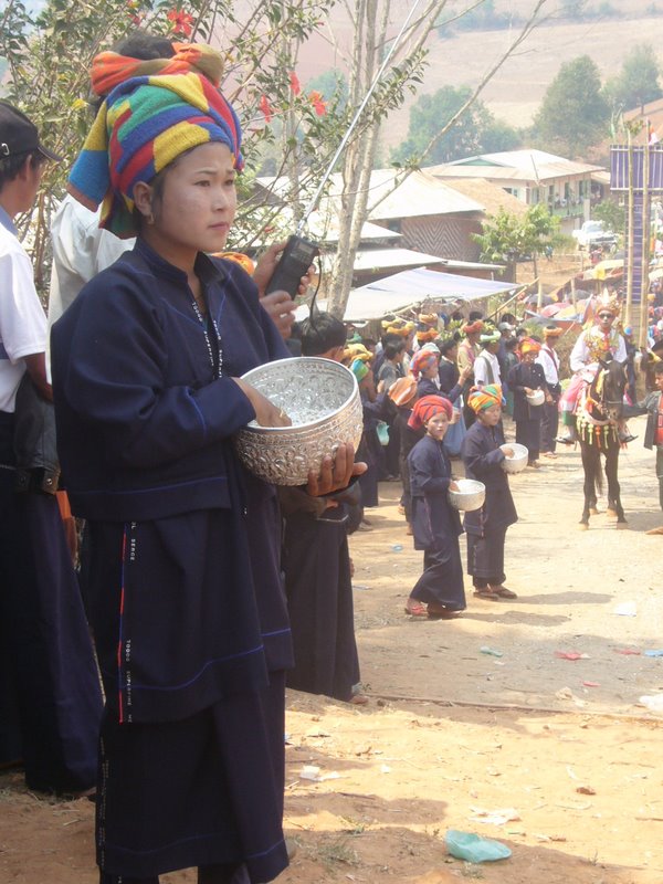 Women stand at the sides and shower them with petals.
